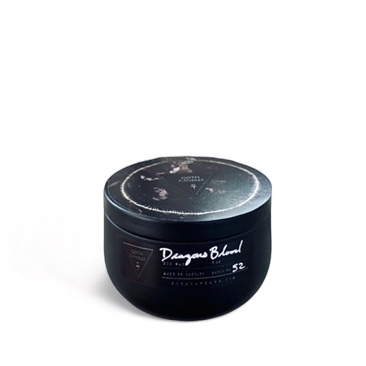 Dark and moody gothic candle in a sleek black tin labeled “Dragon’s Blood,” featuring a mystical design. Perfect for witchy home decor, occult aesthetics, and candle lovers. Hand-poured soy wax candle with an enchanting scent for a magical ambiance.