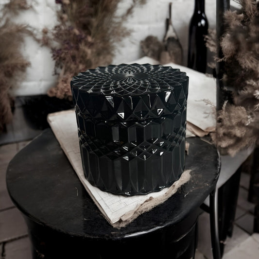 Elegant black gothic candle in a vintage-inspired cut glass jar with intricate geometric patterns. Perfect for dark home decor, witchy aesthetics, and alternative gothic candle lovers. Hand-poured luxury candle for a mysterious and moody ambiance