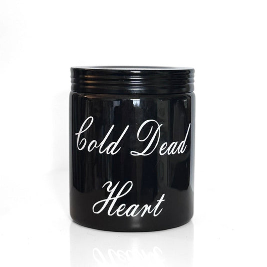 Black candle with 'Cold Dead Heart' text on a white background
