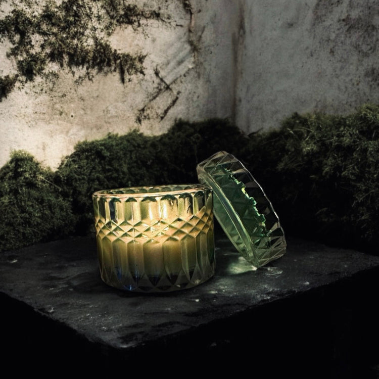 Gothic candle in an iridescent cut-glass jar, glowing against a moody, mossy backdrop. Perfect for dark home decor, witchy aesthetics, and alternative candle lovers. Hand-poured luxury candle for an eerie yet elegant ambiance