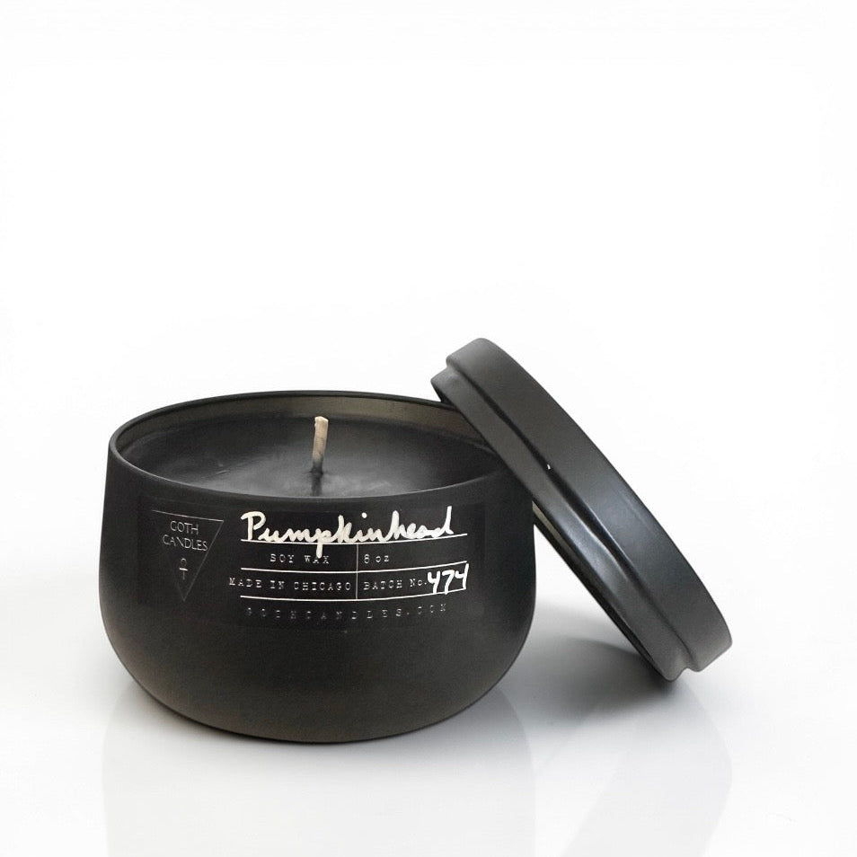 Black Pumpkin goth candle with lid on a white background
