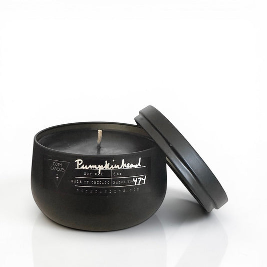 Black Pumpkin goth candle with lid on a white background