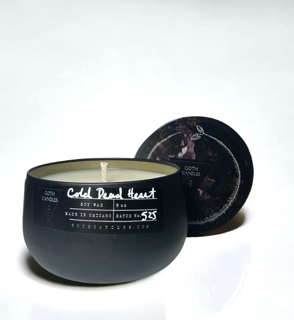 Black candle with white text cold dead heart on a white background