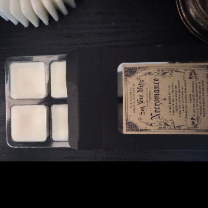 Soy wax melts in a mold with a label on a dark surface