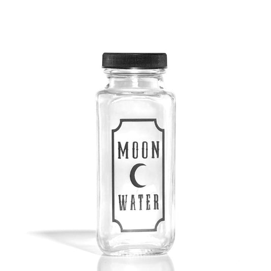 Clear glass bottle labeled 'Moon Water' with a black lid on a white background