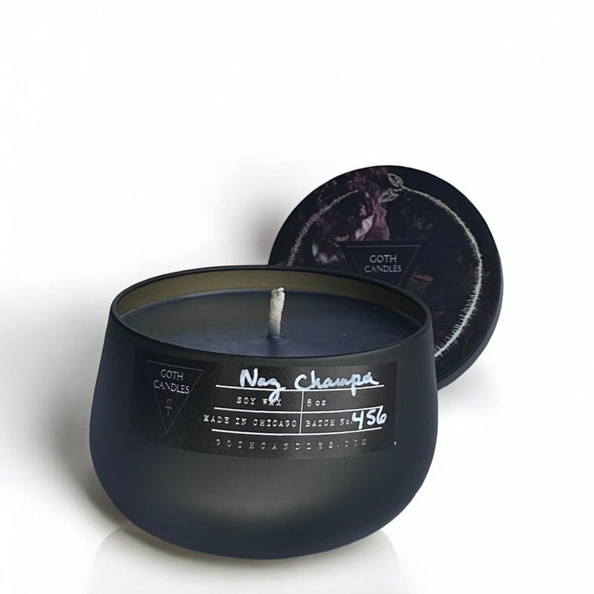Black nag champs candle with a label on a white background