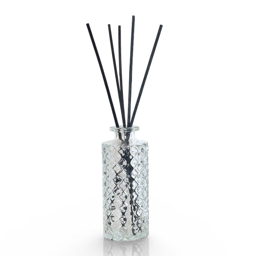 Diffuser bottle with black sticks on a white background