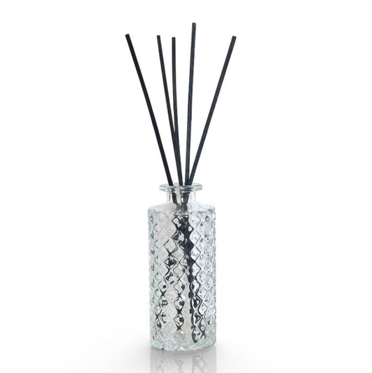 Diffuser bottle with black sticks on a white background